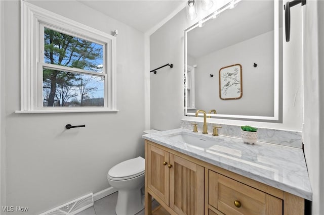 bathroom featuring vanity, tile patterned floors, and toilet