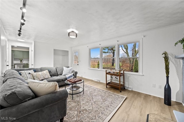 living room with track lighting and hardwood / wood-style floors