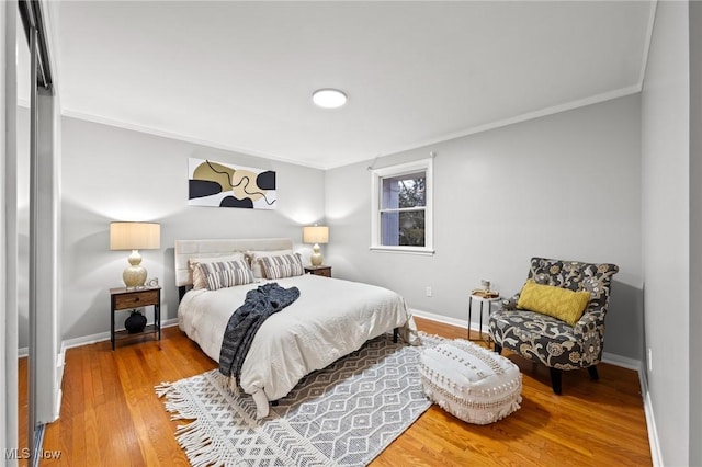 bedroom with wood-type flooring and crown molding