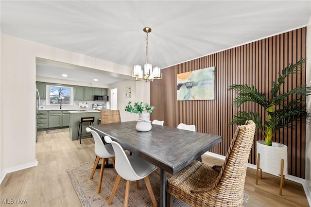 dining area featuring an inviting chandelier and light wood-type flooring