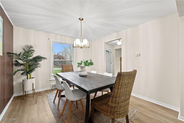 dining area featuring an inviting chandelier and light wood-type flooring