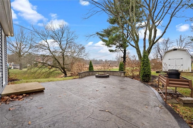 view of patio with a fire pit and a storage unit