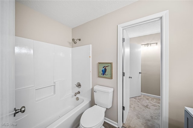 full bathroom featuring vanity, washtub / shower combination, a textured ceiling, and toilet