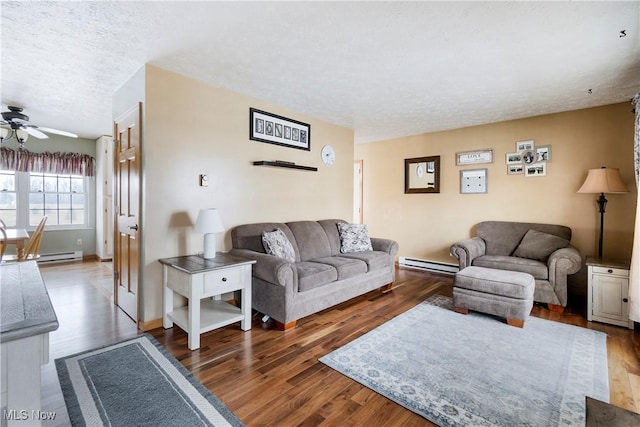 24886 Sherman St, Homeworth, OH 44634 - living room featuring a baseboard radiator, ceiling fan, and wood finished floors