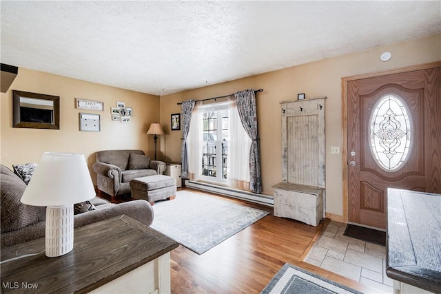 24886 Sherman St, Homeworth, OH 44634 - living room with a textured ceiling, baseboards, a baseboard heating unit, and wood finished floors