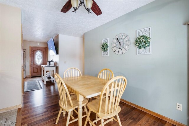 24886 Sherman St, Homeworth, OH 44634 - dining area with a textured ceiling, ceiling fan, baseboards, and wood finished floors