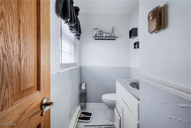 24886 Sherman St, Homeworth, OH 44634 - half bathroom featuring baseboards, a baseboard radiator, vanity, and toilet