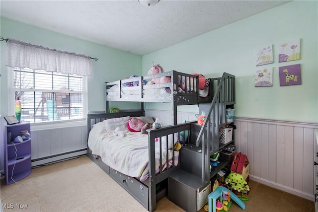 24886 Sherman St, Homeworth, OH 44634 - carpeted bedroom featuring a wainscoted wall, a baseboard heating unit, and a textured ceiling