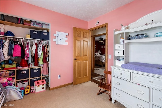 24886 Sherman St, Homeworth, OH 44634 - bedroom featuring a textured ceiling, baseboards, light colored carpet, and a closet