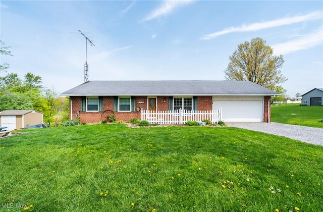 24886 Sherman St, Homeworth, OH 44634 - ranch-style home featuring brick siding, driveway, a front lawn, and a garage