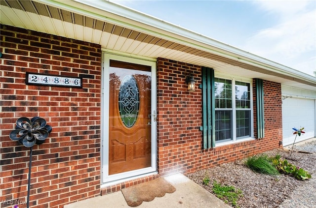 24886 Sherman St, Homeworth, OH 44634 - doorway to property featuring brick siding and a garage