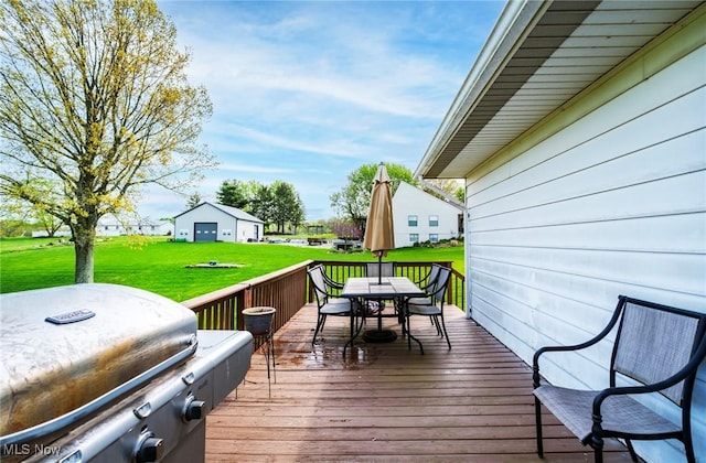24886 Sherman St, Homeworth, OH 44634 - deck with outdoor dining area, a lawn, and a grill