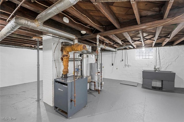 basement featuring sink and water heater