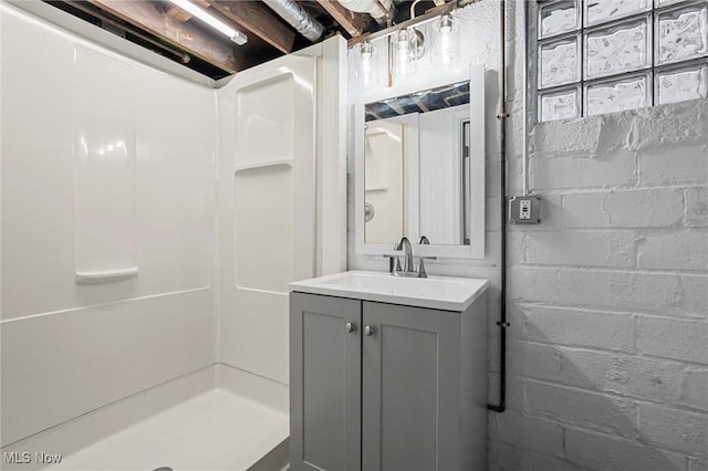 bathroom featuring vanity and a shower