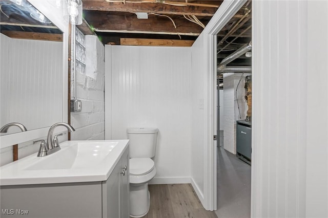 bathroom with vanity, hardwood / wood-style floors, and toilet