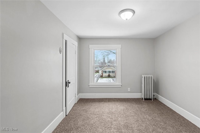 carpeted spare room with radiator