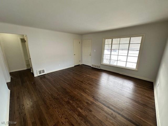 unfurnished room featuring dark hardwood / wood-style flooring