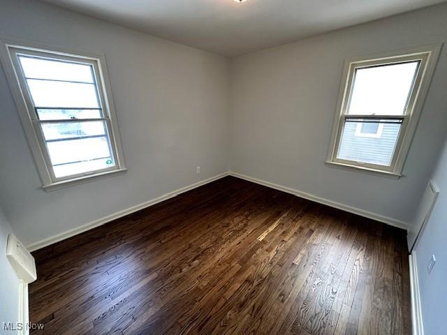 spare room featuring dark hardwood / wood-style flooring