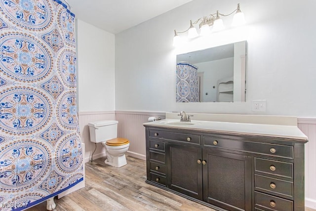 bathroom featuring hardwood / wood-style flooring, vanity, and toilet