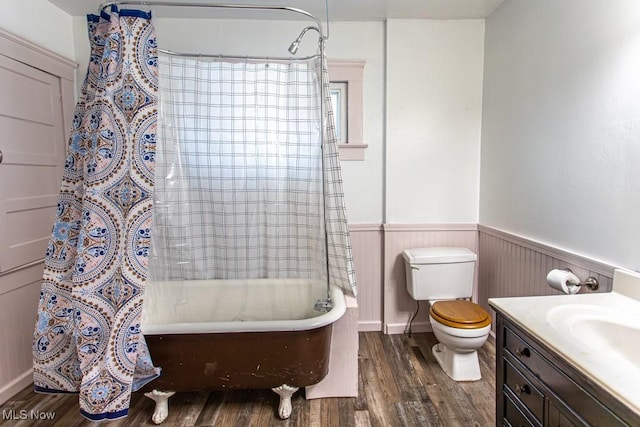 full bathroom featuring vanity, hardwood / wood-style floors, shower / tub combo, and toilet