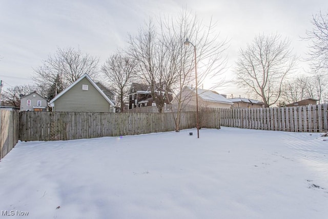 view of yard layered in snow