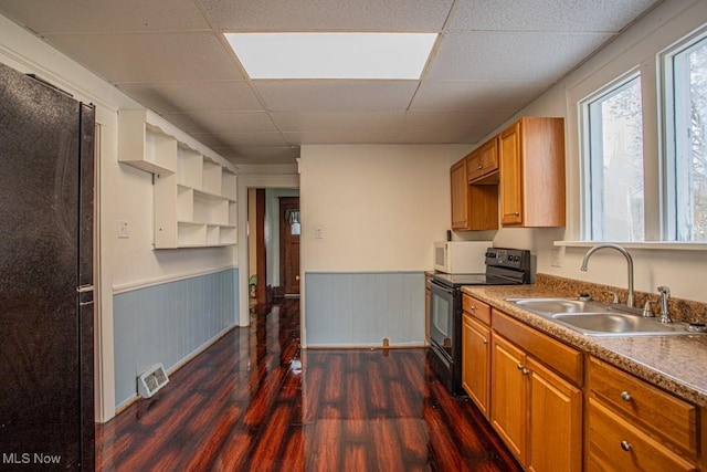 kitchen featuring a paneled ceiling, black electric range, sink, and dark hardwood / wood-style floors