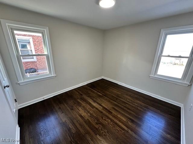 empty room featuring dark wood-type flooring