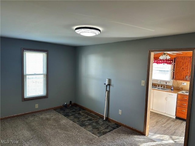 carpeted spare room featuring sink