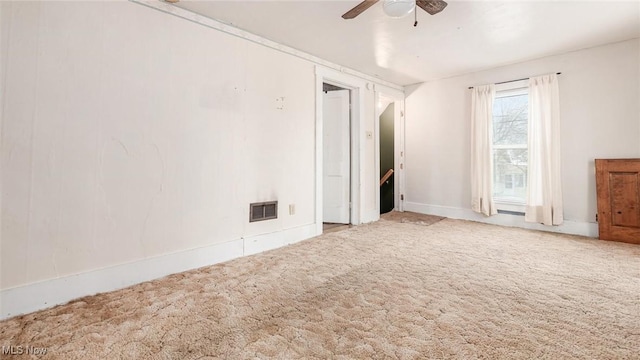 carpeted spare room with ceiling fan