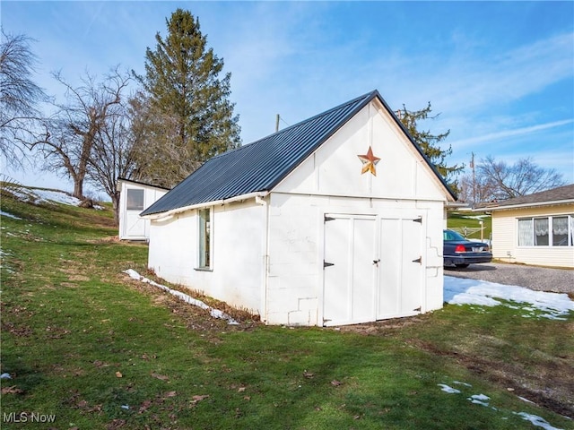 view of outbuilding with a yard