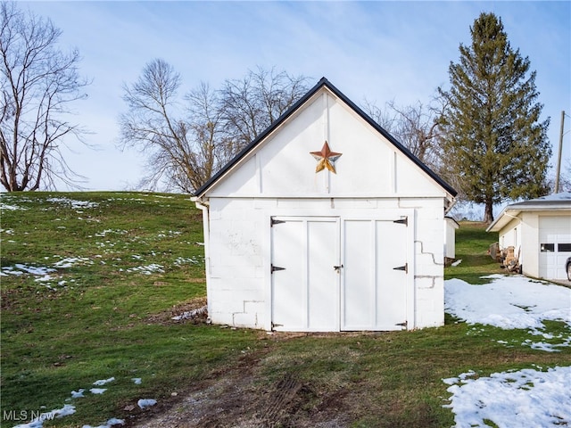 snow covered structure featuring a yard