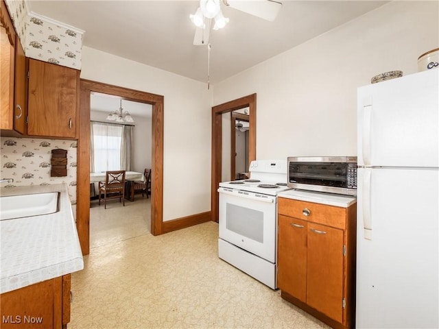 kitchen featuring ceiling fan, sink, and white appliances