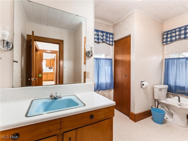 bathroom with crown molding, vanity, and toilet