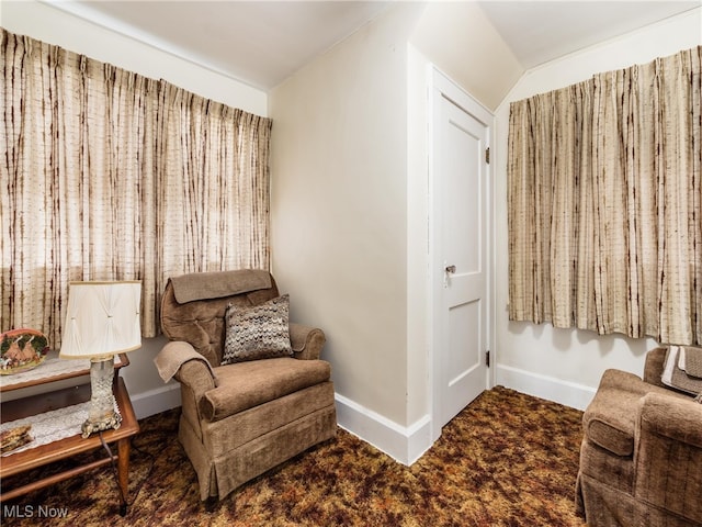 sitting room featuring lofted ceiling and carpet