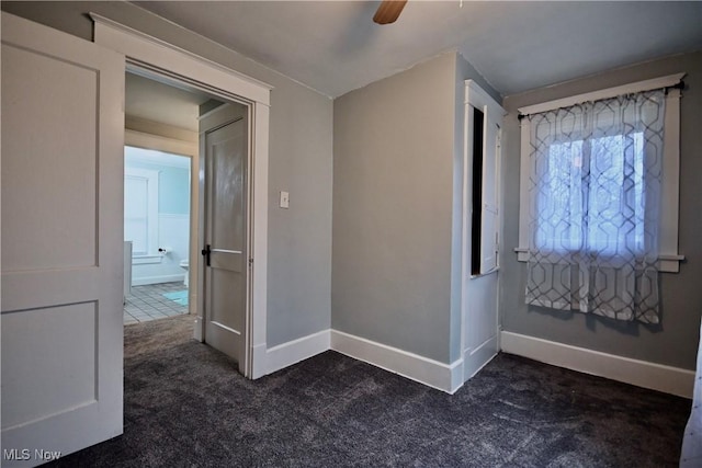 carpeted foyer entrance featuring ceiling fan