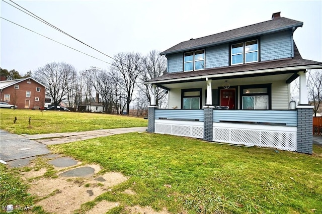 view of front facade featuring covered porch and a front yard