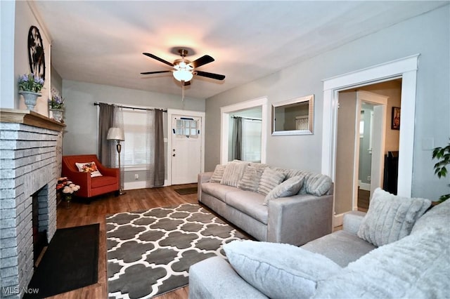 living room featuring a fireplace, dark hardwood / wood-style floors, and ceiling fan