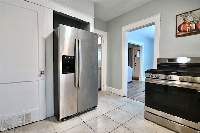 kitchen with stainless steel appliances and light tile patterned floors