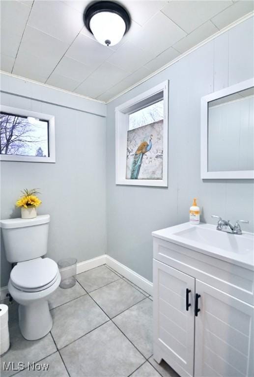 bathroom featuring vanity, tile patterned floors, and toilet