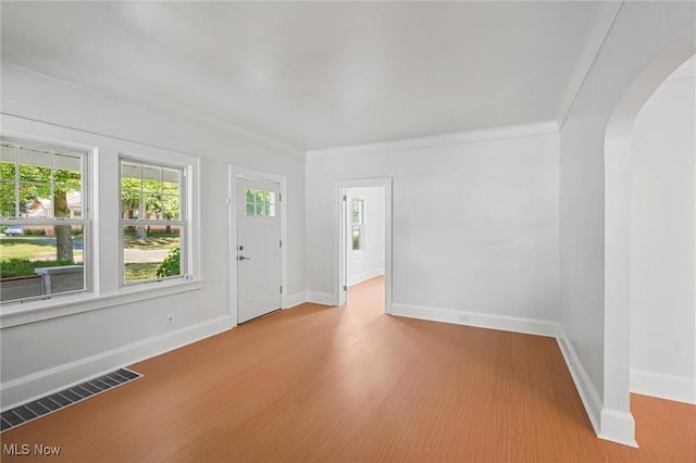 interior space with crown molding and light hardwood / wood-style flooring