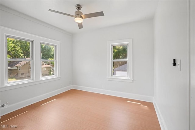 unfurnished room featuring hardwood / wood-style floors and ceiling fan