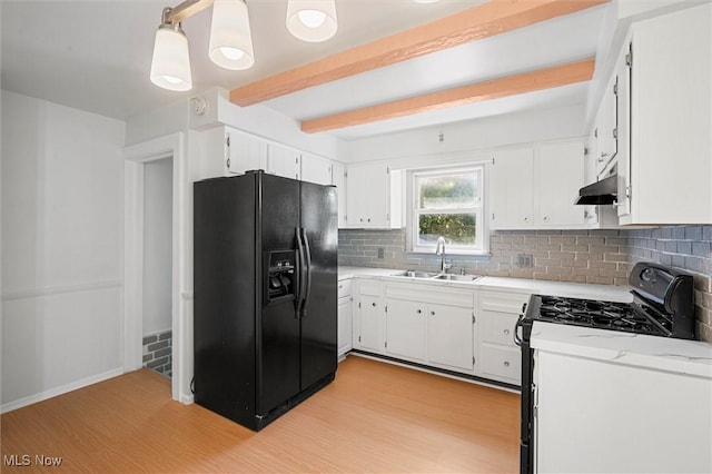 kitchen featuring decorative light fixtures, sink, white cabinets, and black appliances