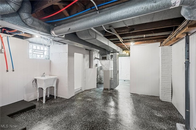 basement with heating unit and sink