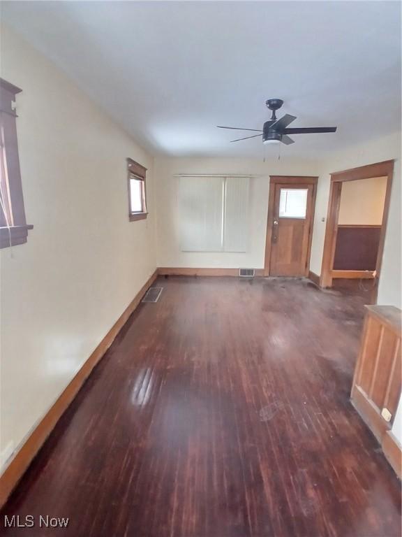 spare room featuring ceiling fan and dark hardwood / wood-style flooring