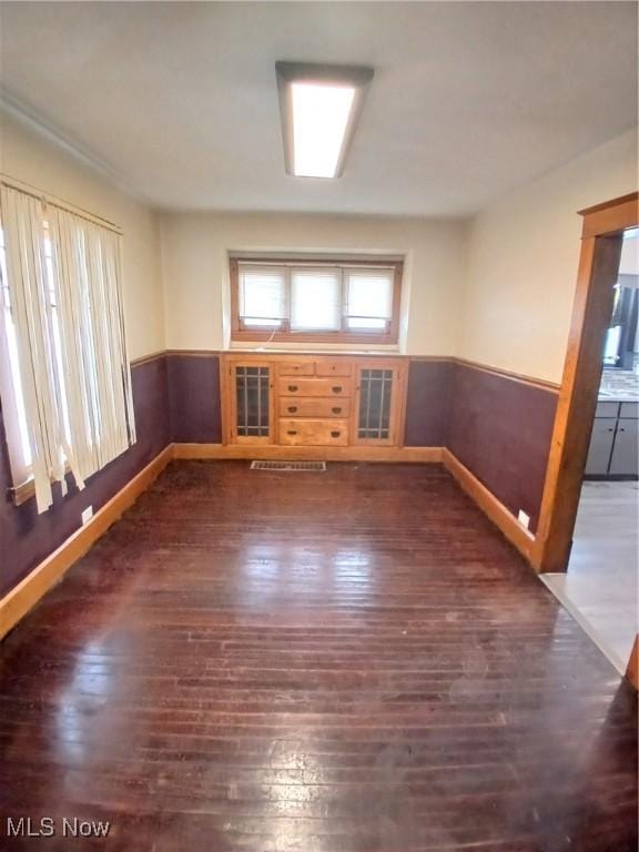 unfurnished room featuring dark wood-type flooring