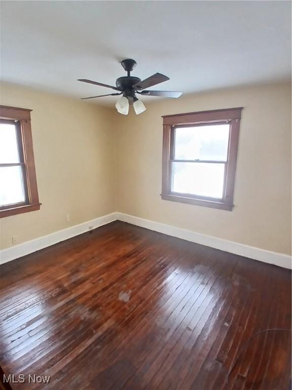 unfurnished room with dark hardwood / wood-style flooring, ceiling fan, and a healthy amount of sunlight