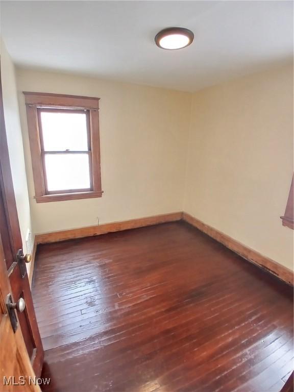 spare room featuring dark hardwood / wood-style flooring