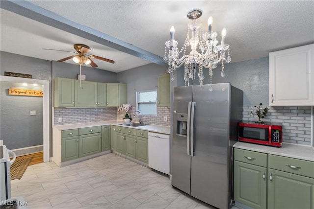 kitchen with stainless steel refrigerator with ice dispenser, sink, white dishwasher, white cabinets, and backsplash