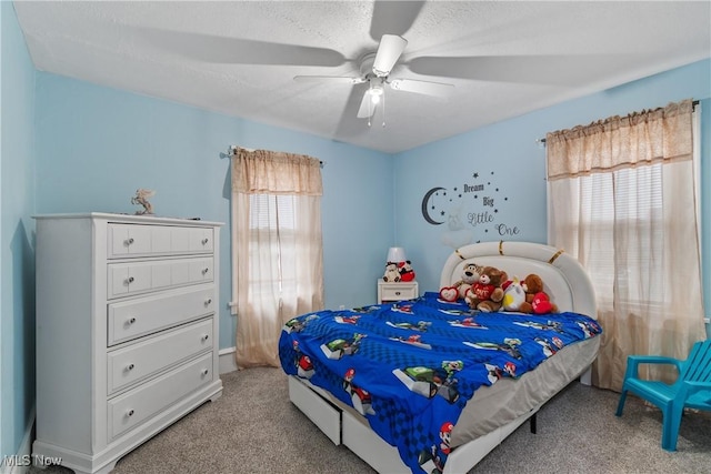 carpeted bedroom featuring a textured ceiling and ceiling fan