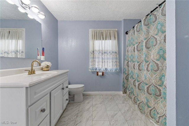 bathroom featuring vanity, a wealth of natural light, and a textured ceiling